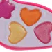 Zestaw Make Up: Paleta do makijażu w kształcie wysokiego obcasa z kremowymi kosmetykami.